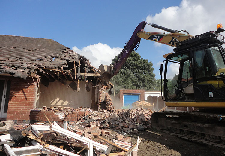 Sheffield demolition experts use hi reach excavator to demolish house